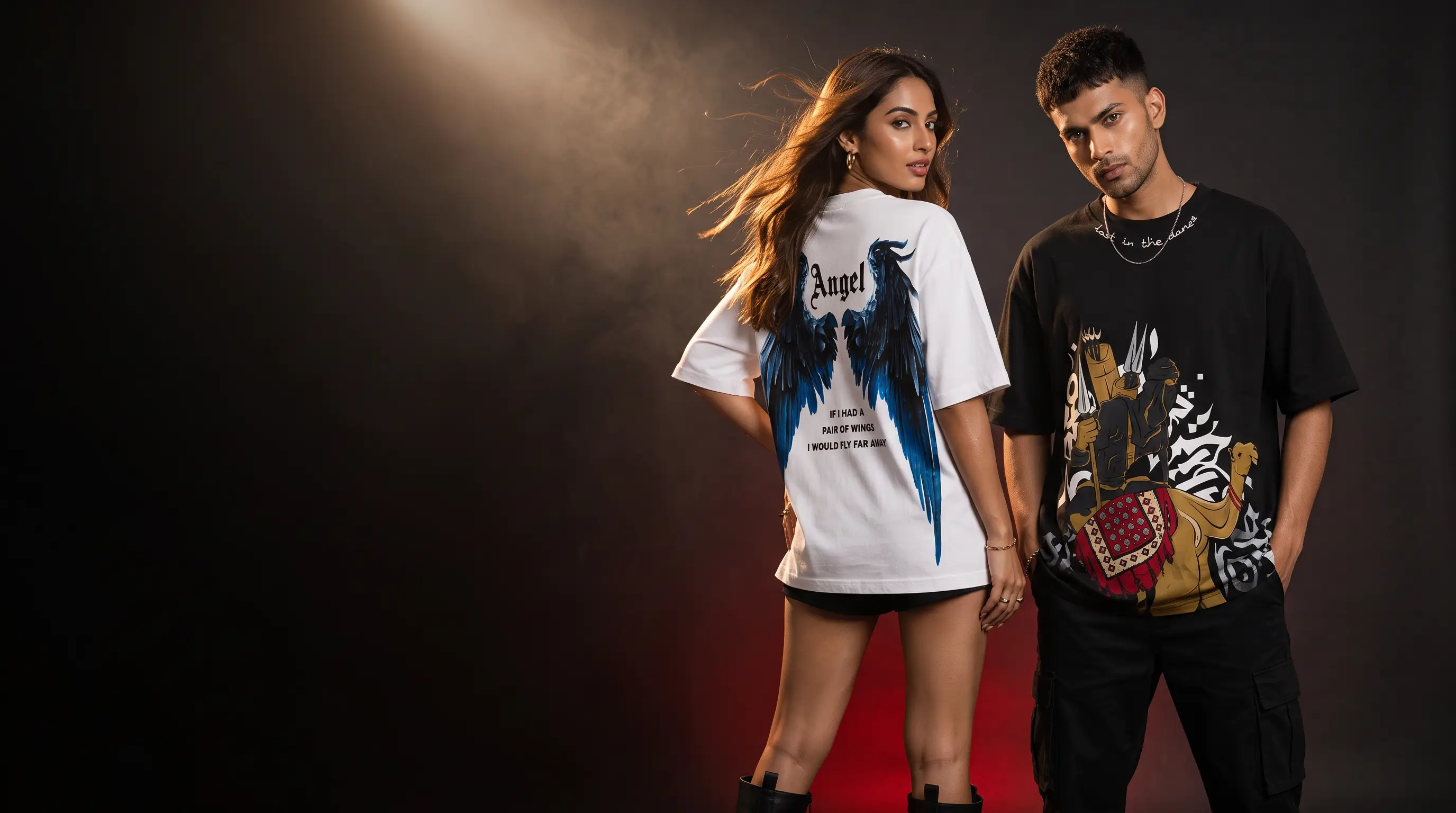 TeeVybe models in the Angel wings tee and the Desert rider tee under studio light