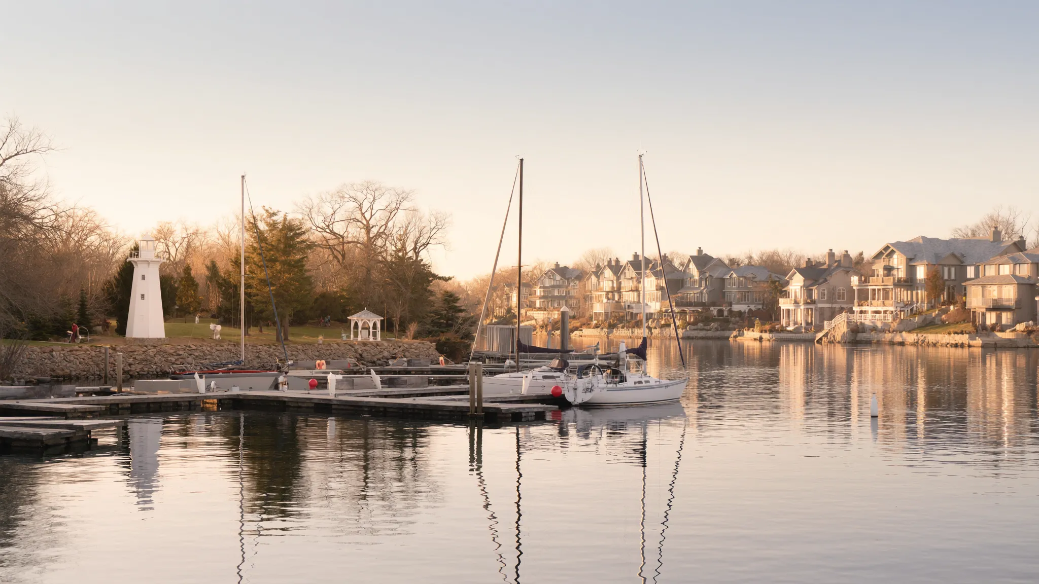Oakville harbour with sailboats and lighthouse at golden hour