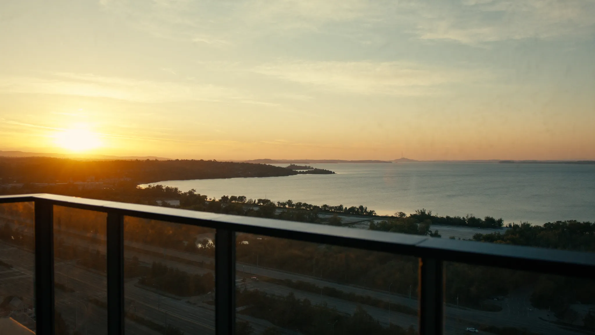 South-facing condo balcony view over Lake Ontario at sunset in Etobicoke