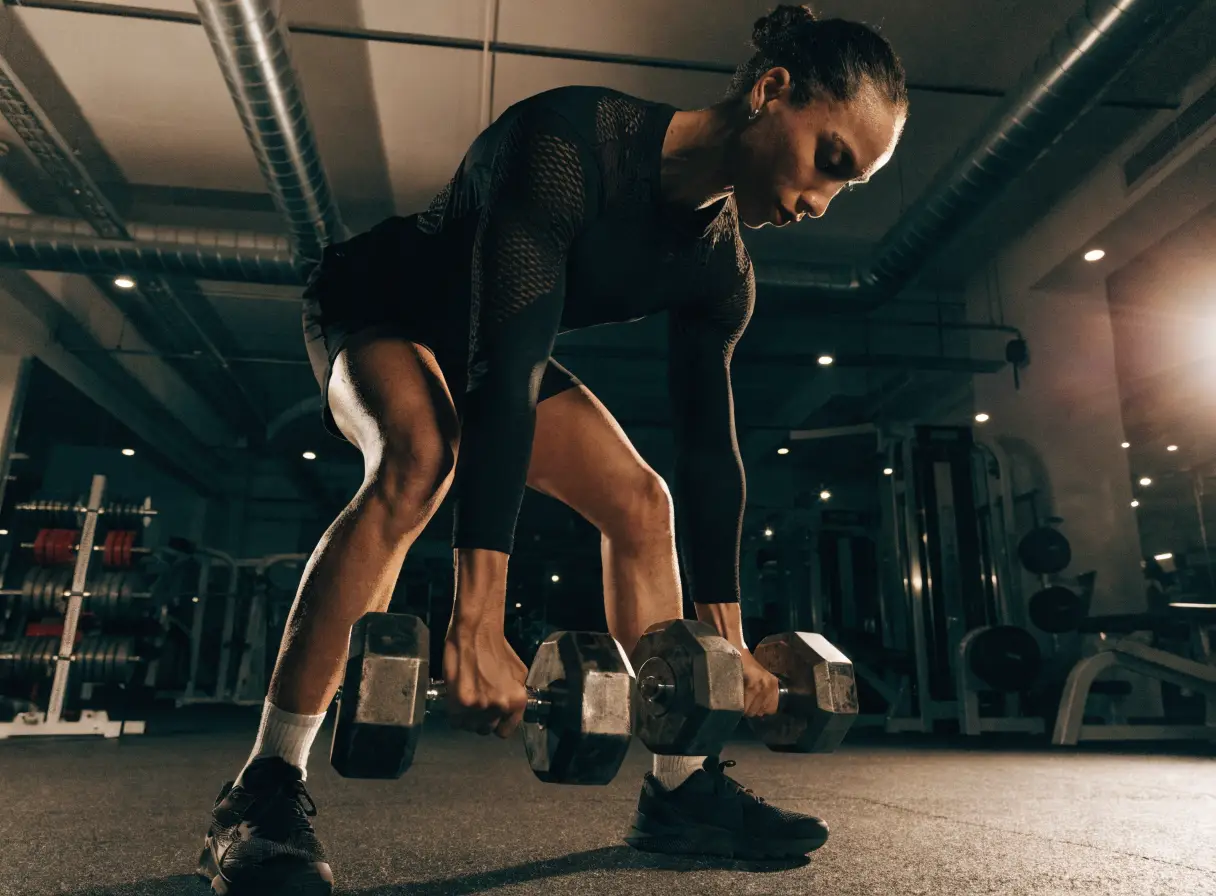 Athlete training with dumbbells