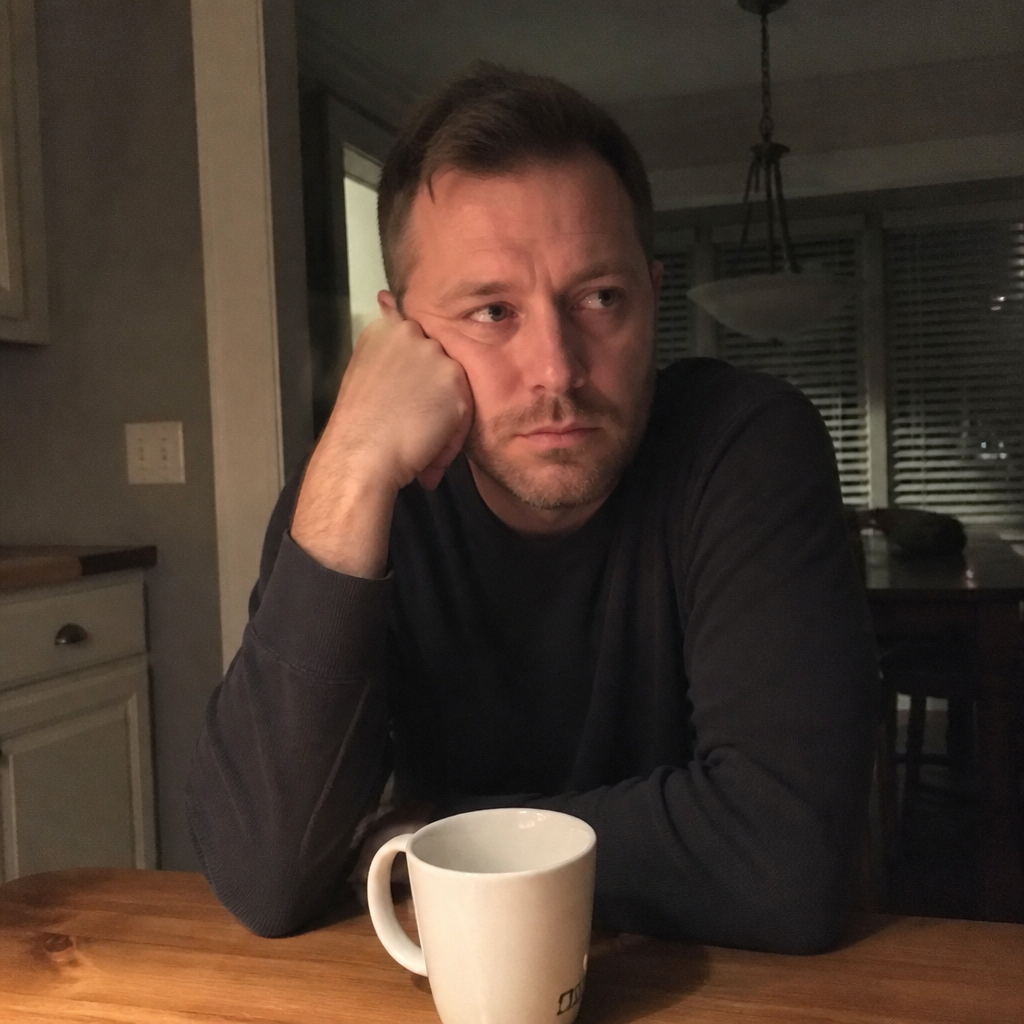 A father at the kitchen table at night