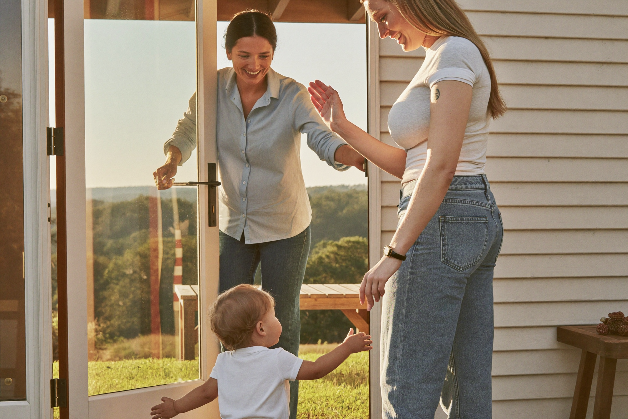 Mother dropping off her toddler with a smiling home daycare caregiver