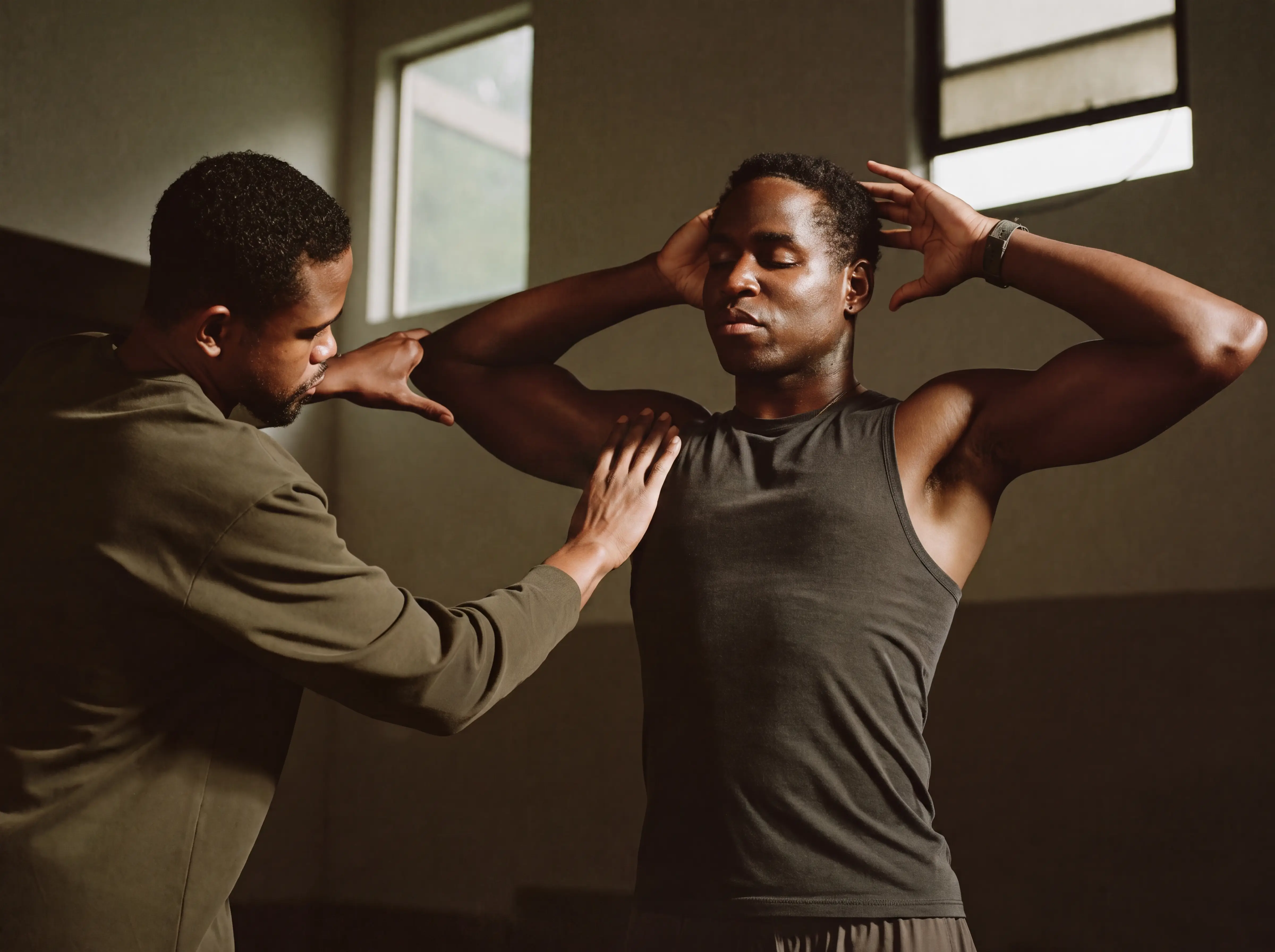 A man having his shoulder mobility assessed before any programme is written