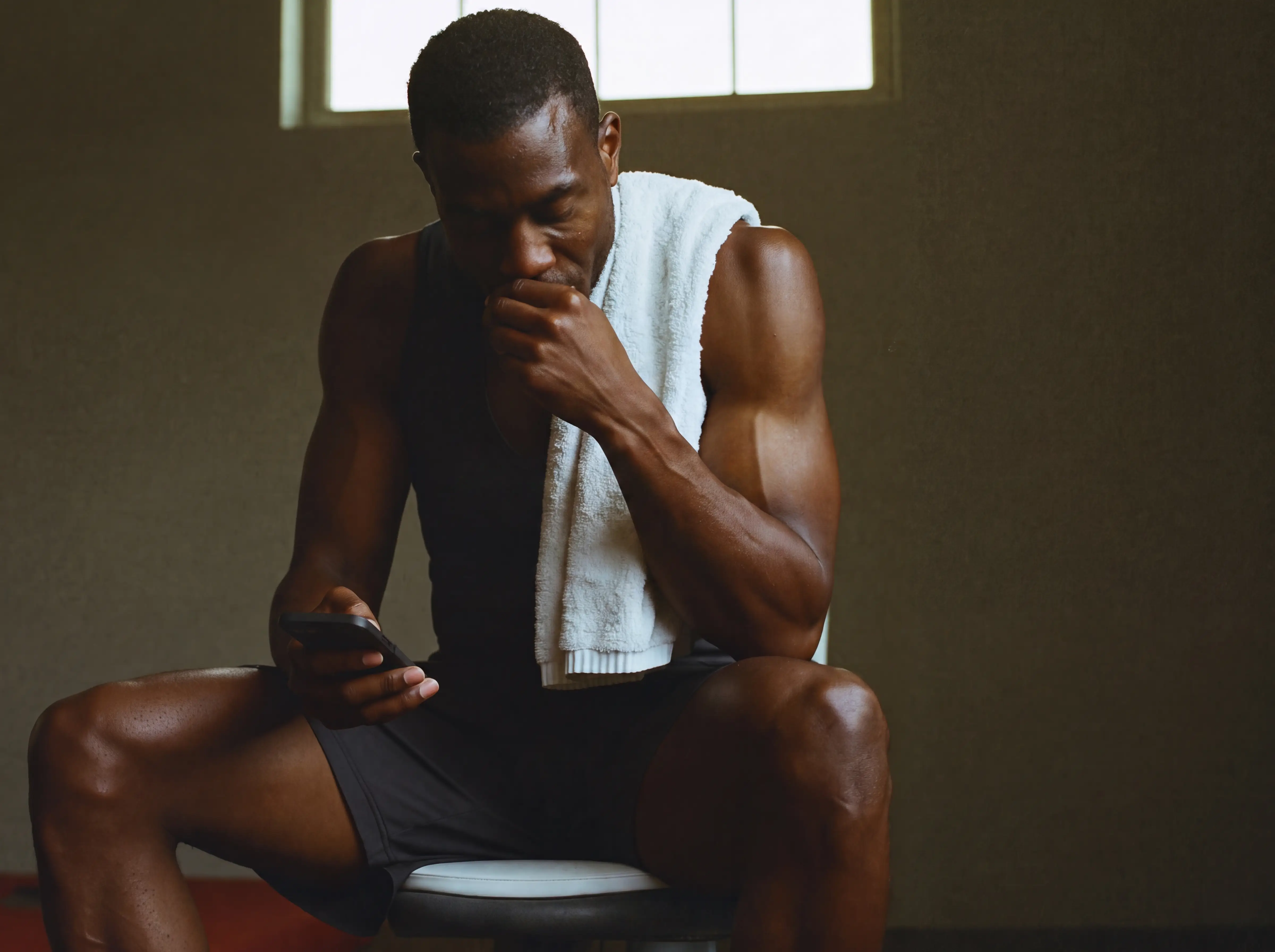 The same man logging his session on a bench after training