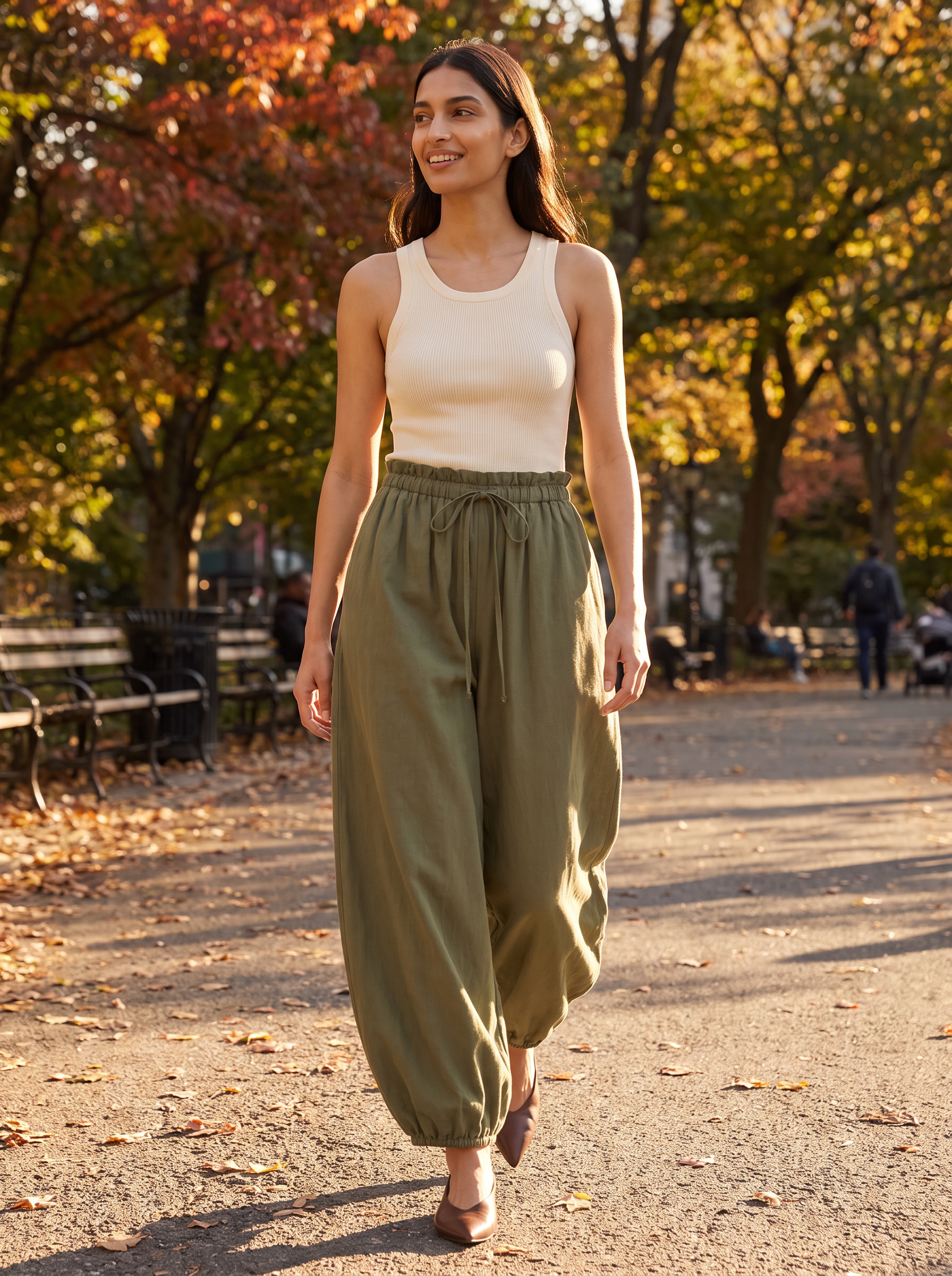 Woman wearing olive balloon pants in autumn park