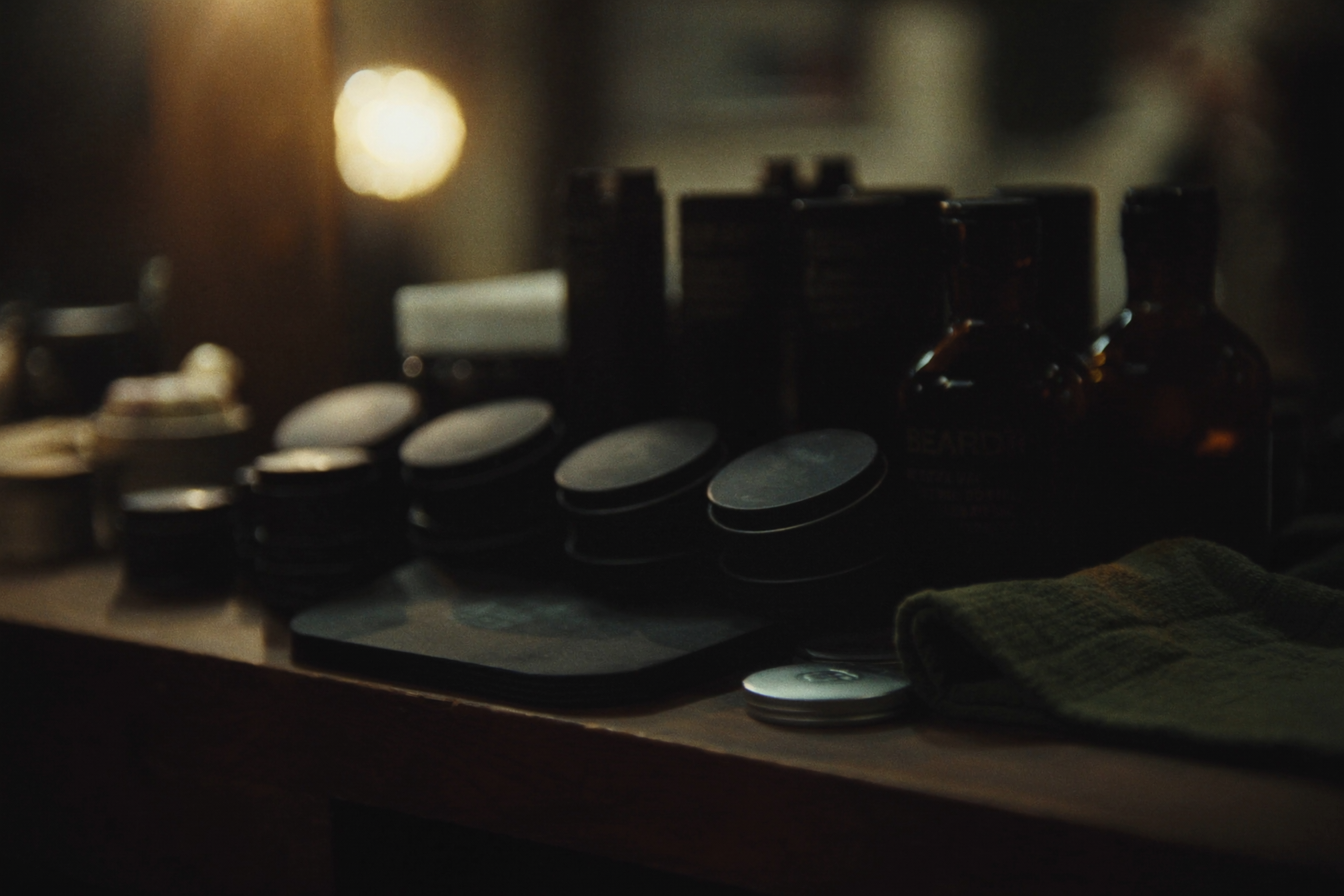 Shelf of grooming products and pomade tins