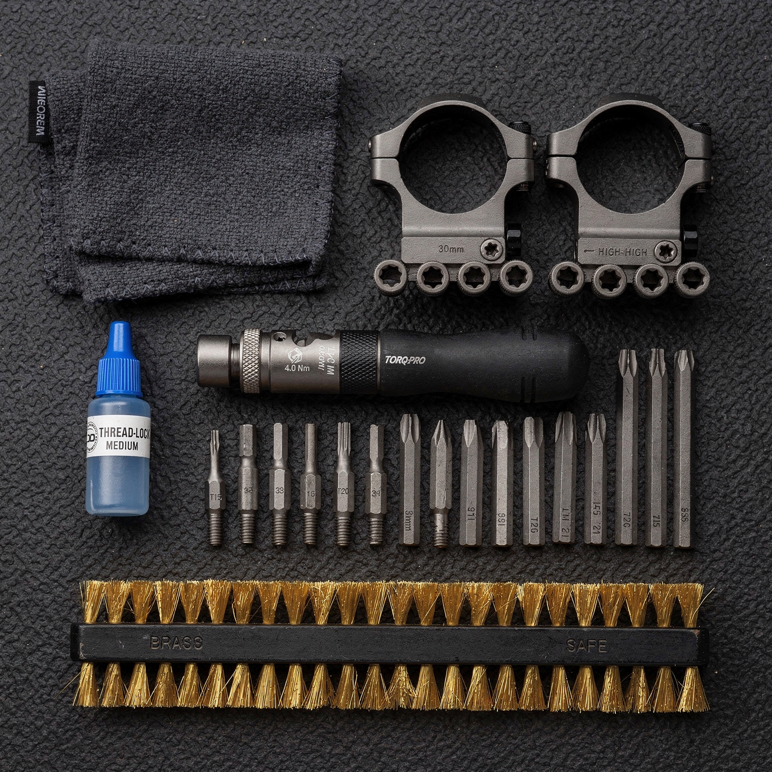 Precision gunsmithing tools laid out in order on a bench mat