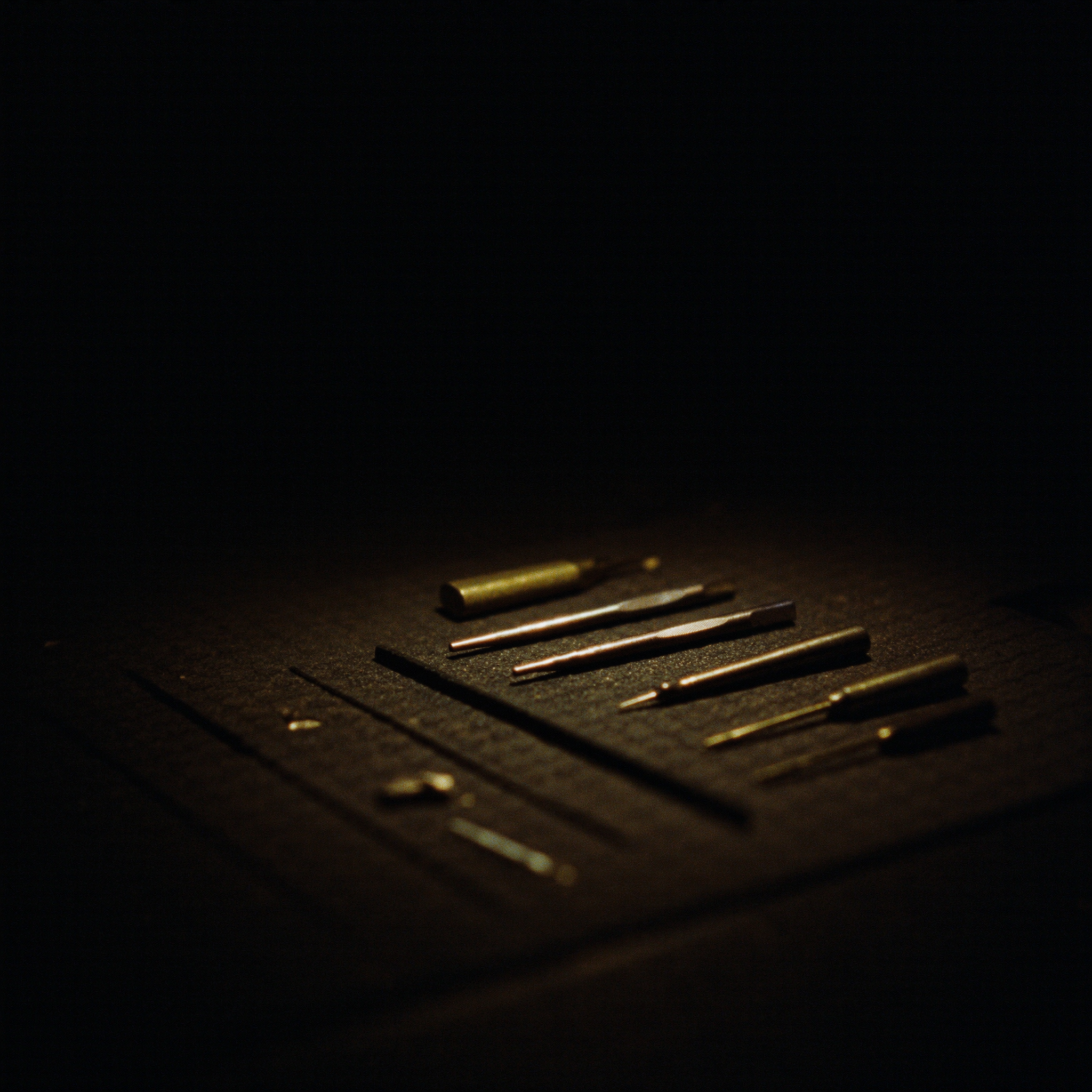 Precision gunsmithing tools arranged on a bench mat