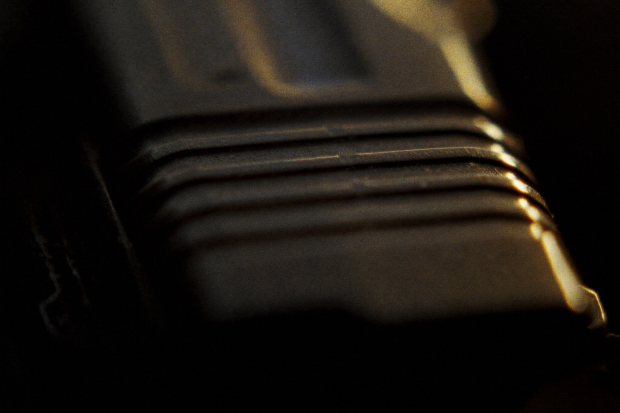 Macro detail of pistol slide serrations after service