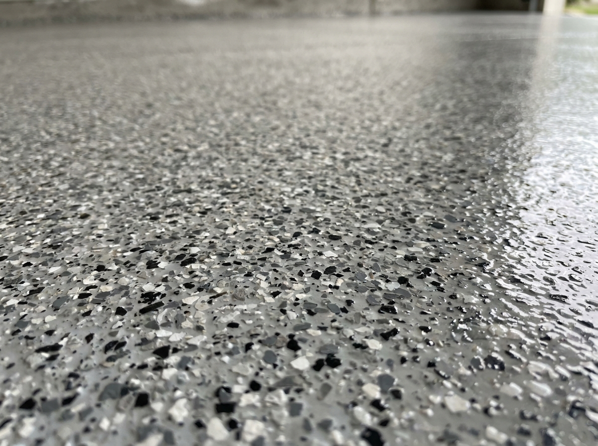 Domino flake blend — light gray, dark gray, black, and white epoxy floor