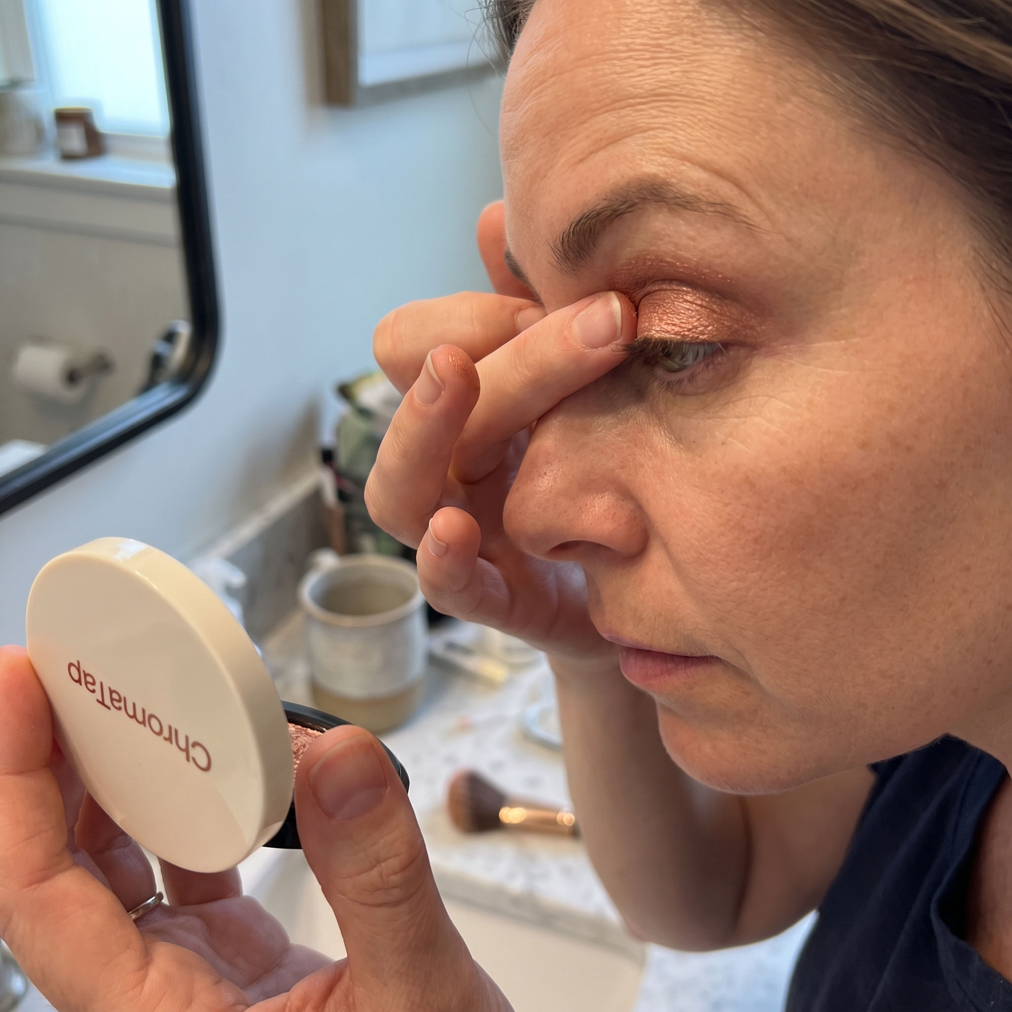 Applying ChromaTap eyeshadow with a fingertip