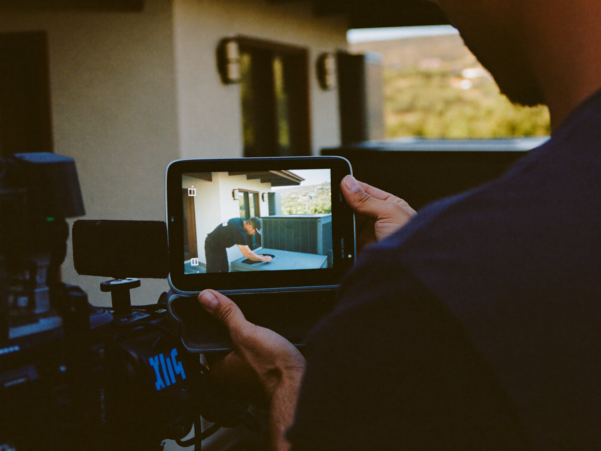 Camera monitor showing a technician being filmed on site