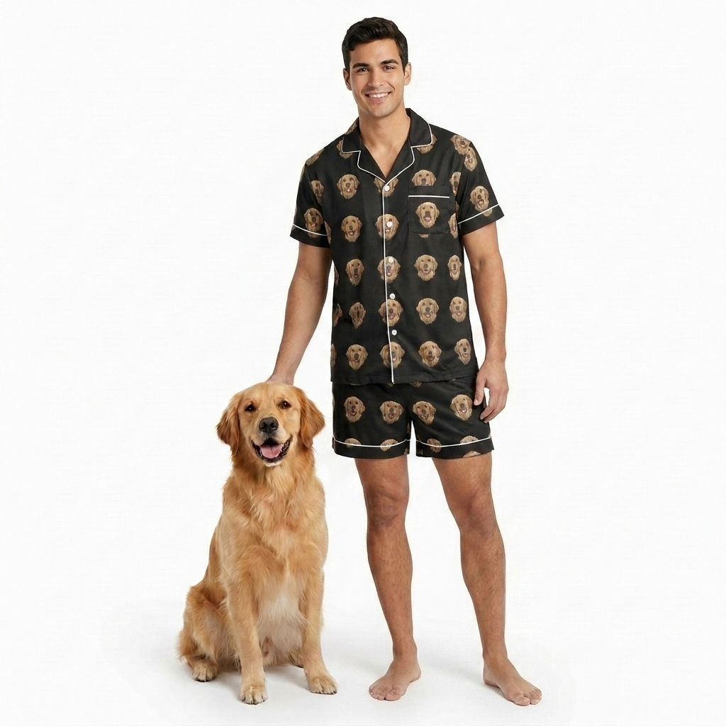 The Jammies short-sleeve button-down pajama set in black with an all-over pet face print, worn by a model with his golden retriever