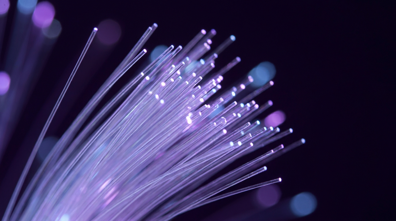 Fiber optics - glowing strands of optical fiber on dark