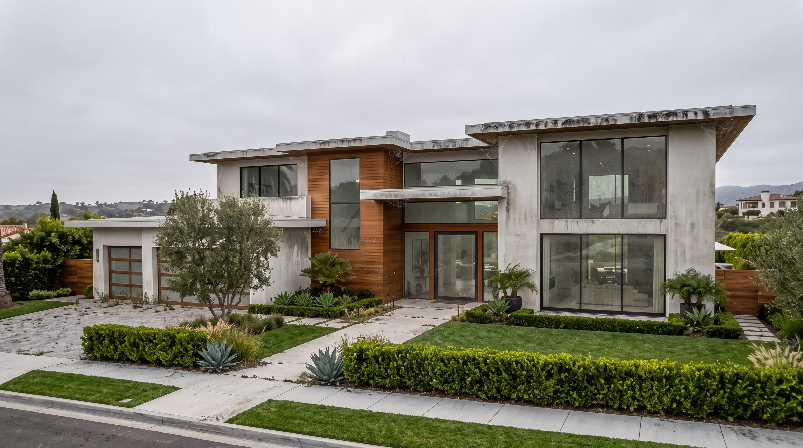 Home exterior with grimy windows, dusty walls, and streaked eaves before cleaning
