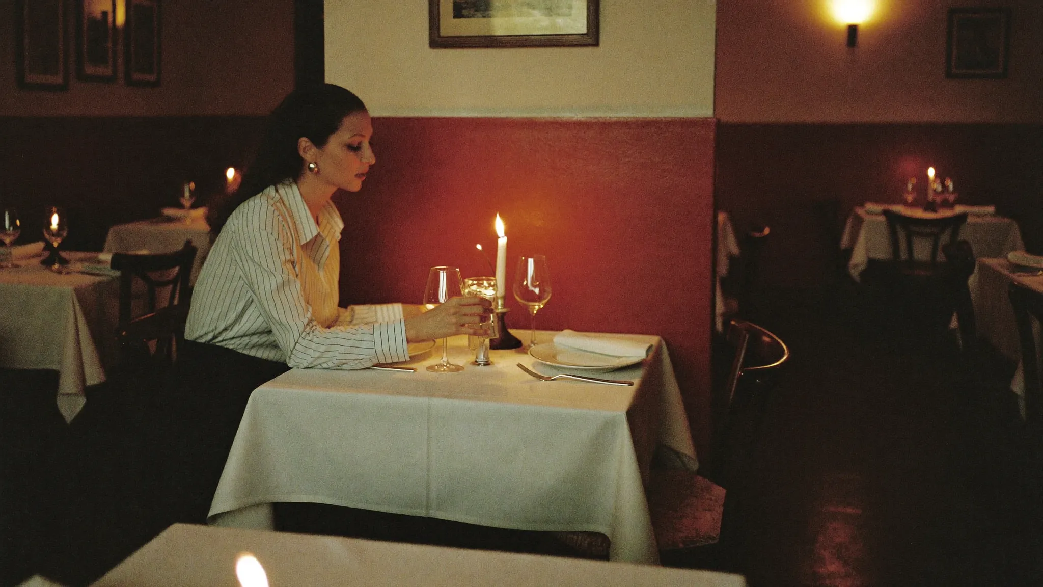 Host lighting candles at the corner table