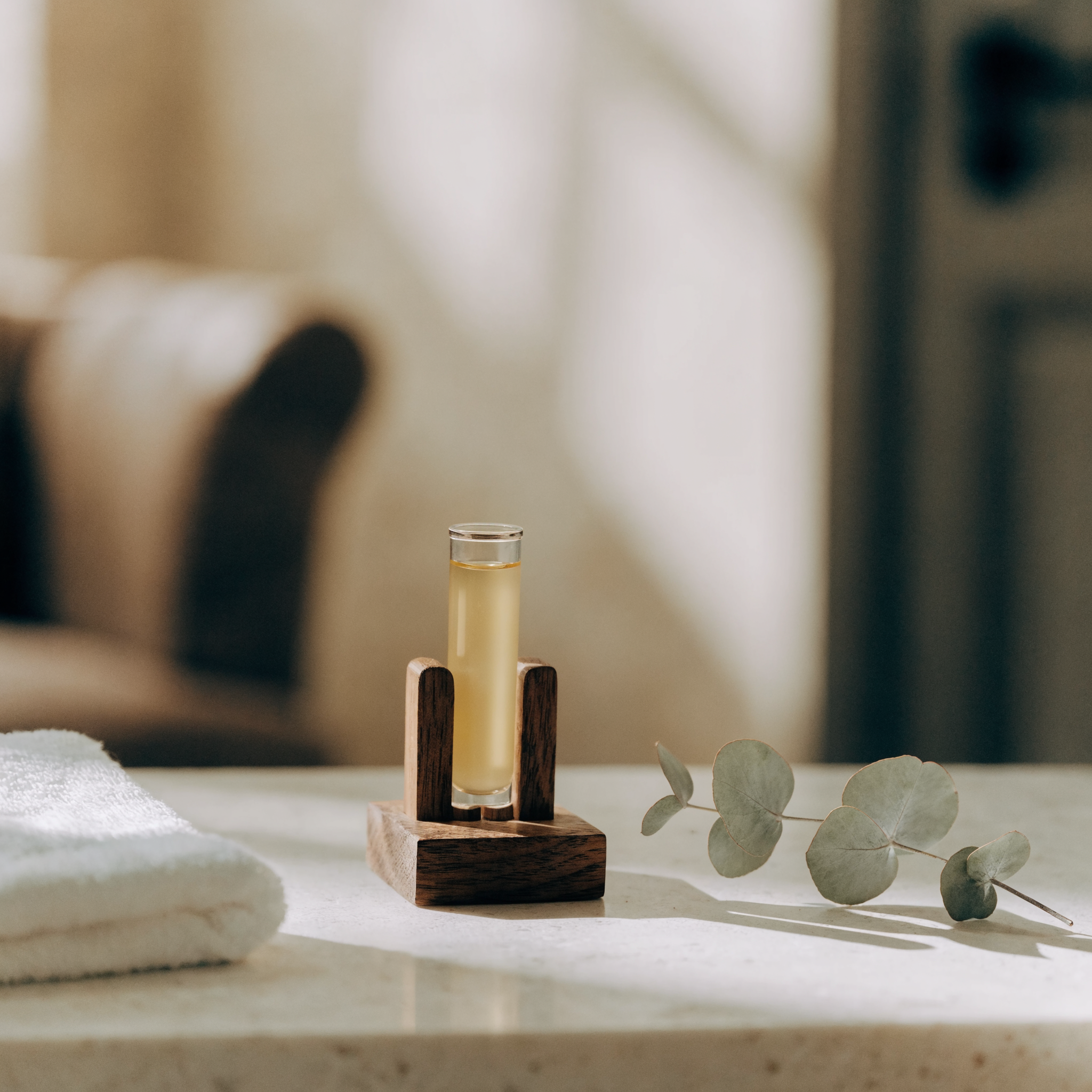 A tube of golden serum standing in a wooden rack