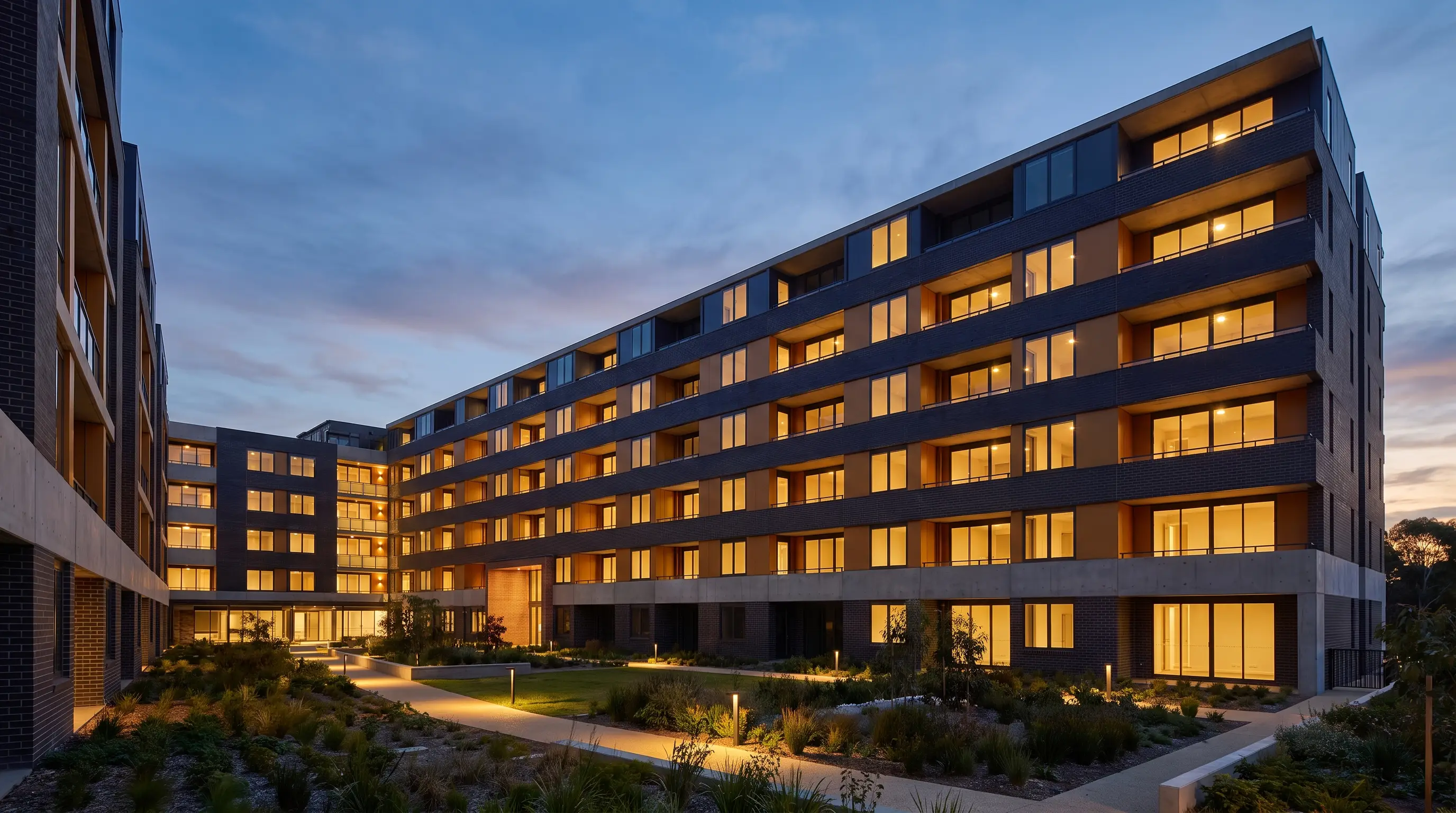 Institutional-grade multifamily building exterior at dusk