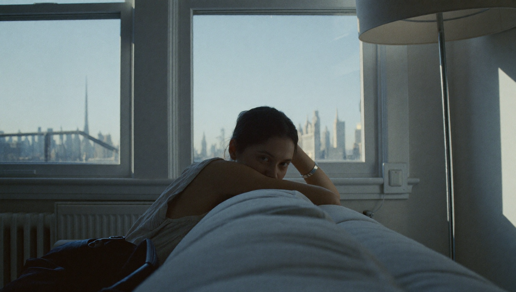 A person resting thoughtfully at home in soft morning light