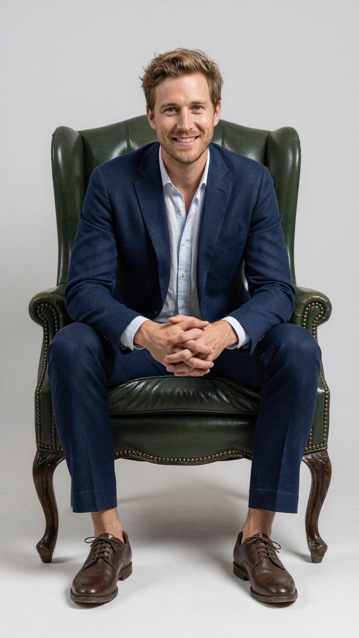 Lucas seated in a green leather armchair, in private consultation