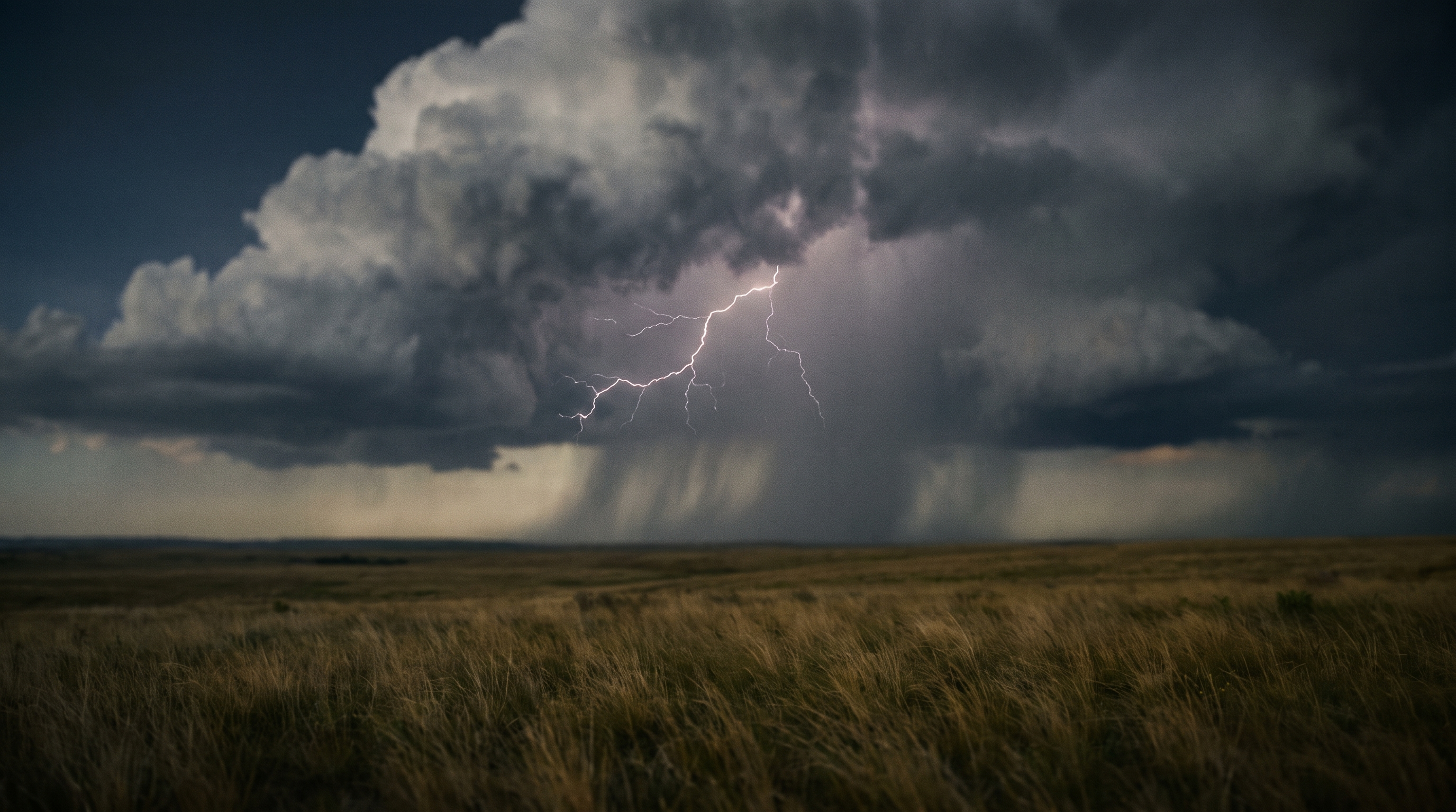 Thunderheads rolling over dark open plains.