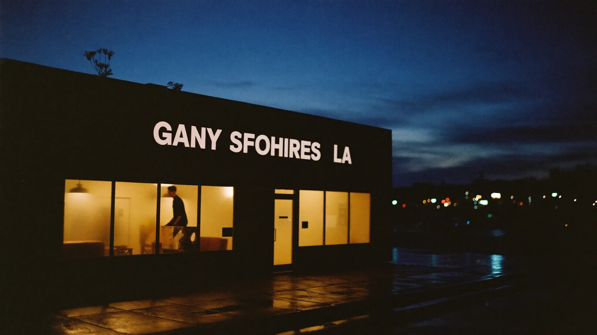 Independent storefront glowing warmly at blue hour