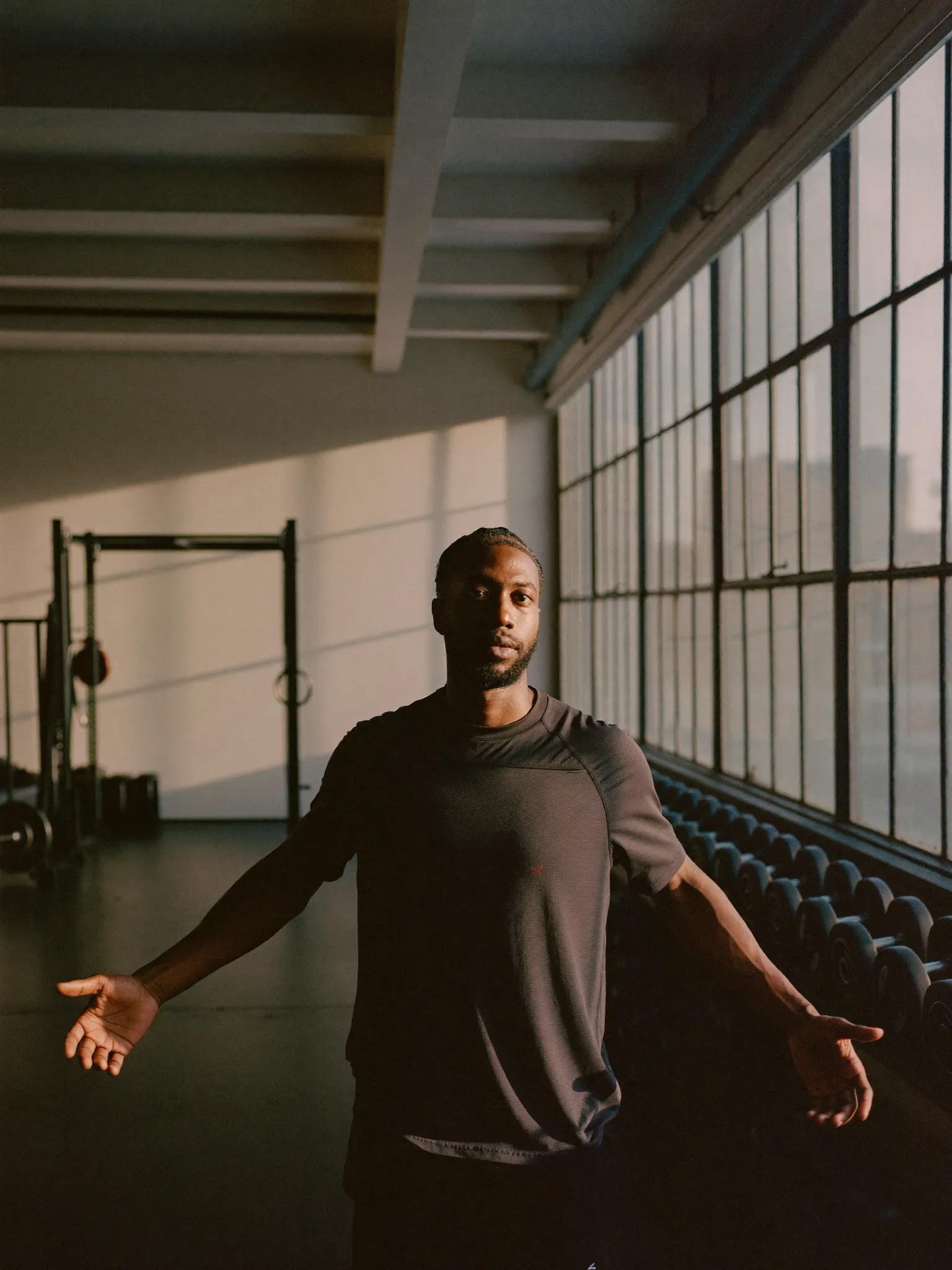 Owner of a boutique fitness studio standing in the training room in the early morning