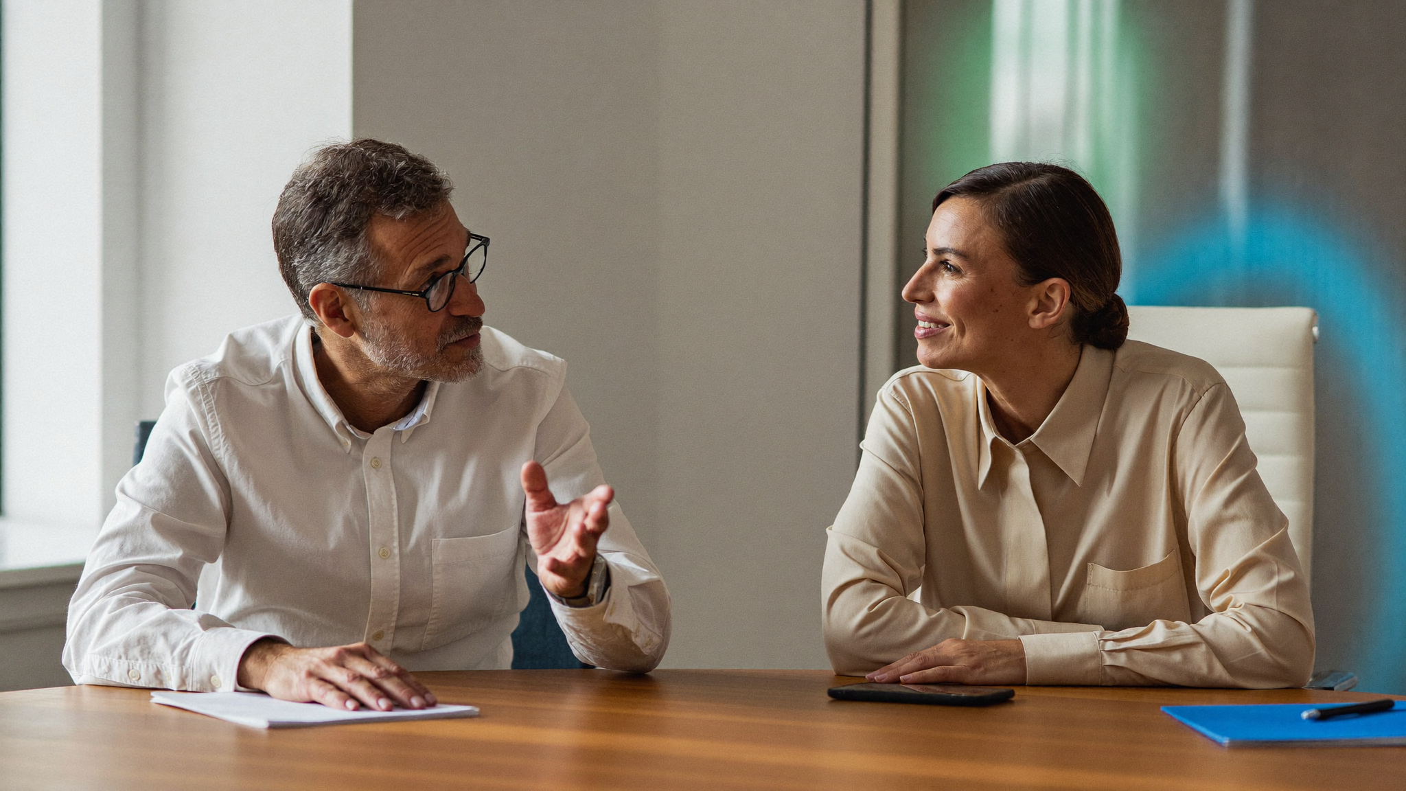 Two senior professionals in focused conversation