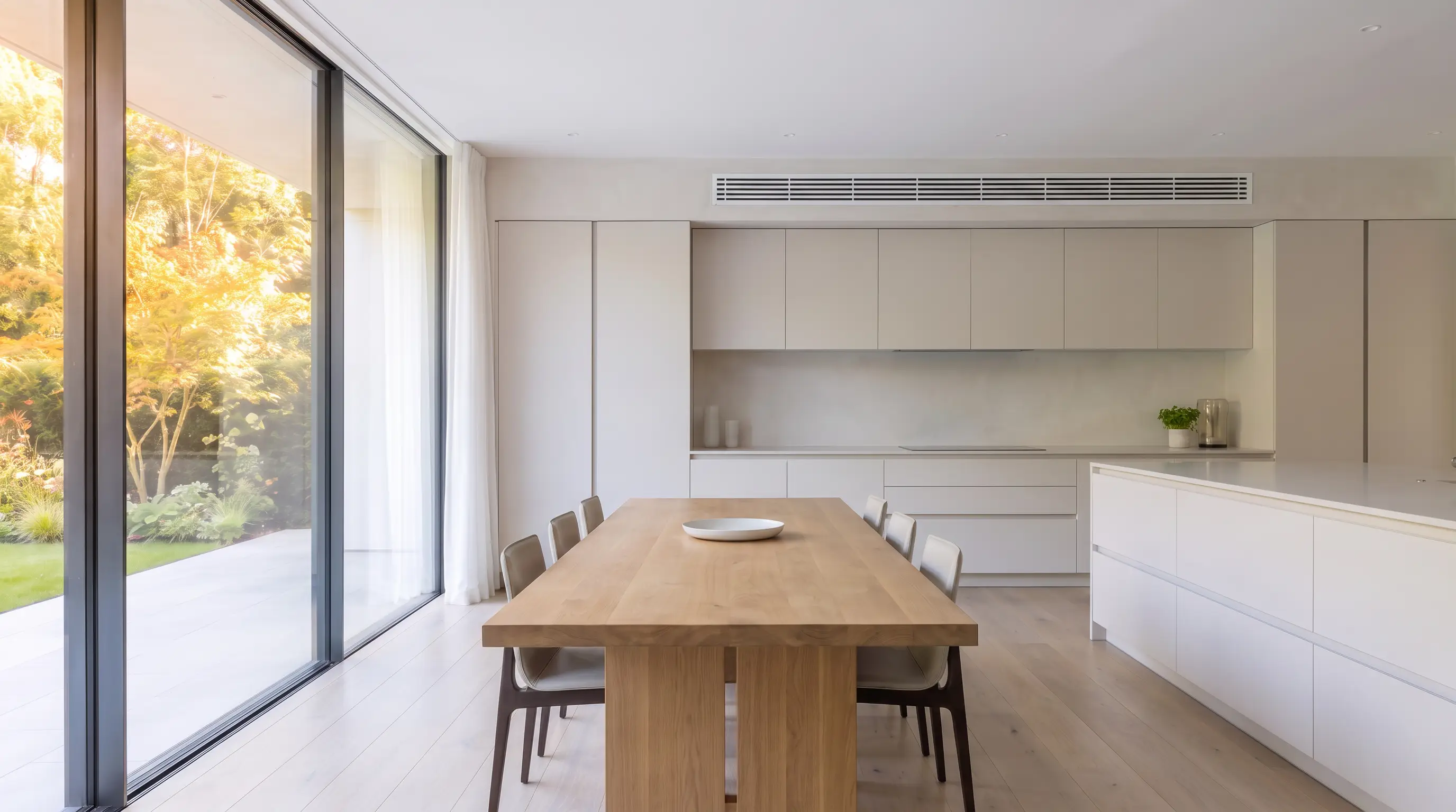 Kitchen-dining room with a slim linear grille above the cabinetry