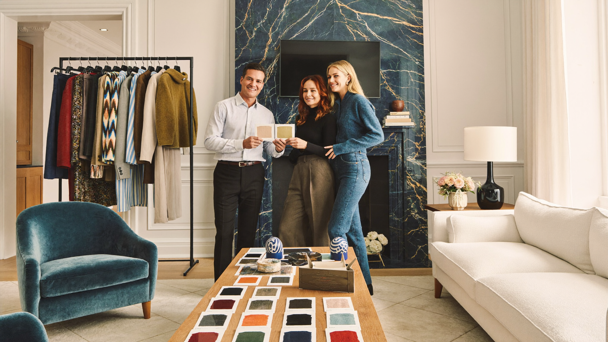 Designers reviewing fabric and colour swatches with a client at home