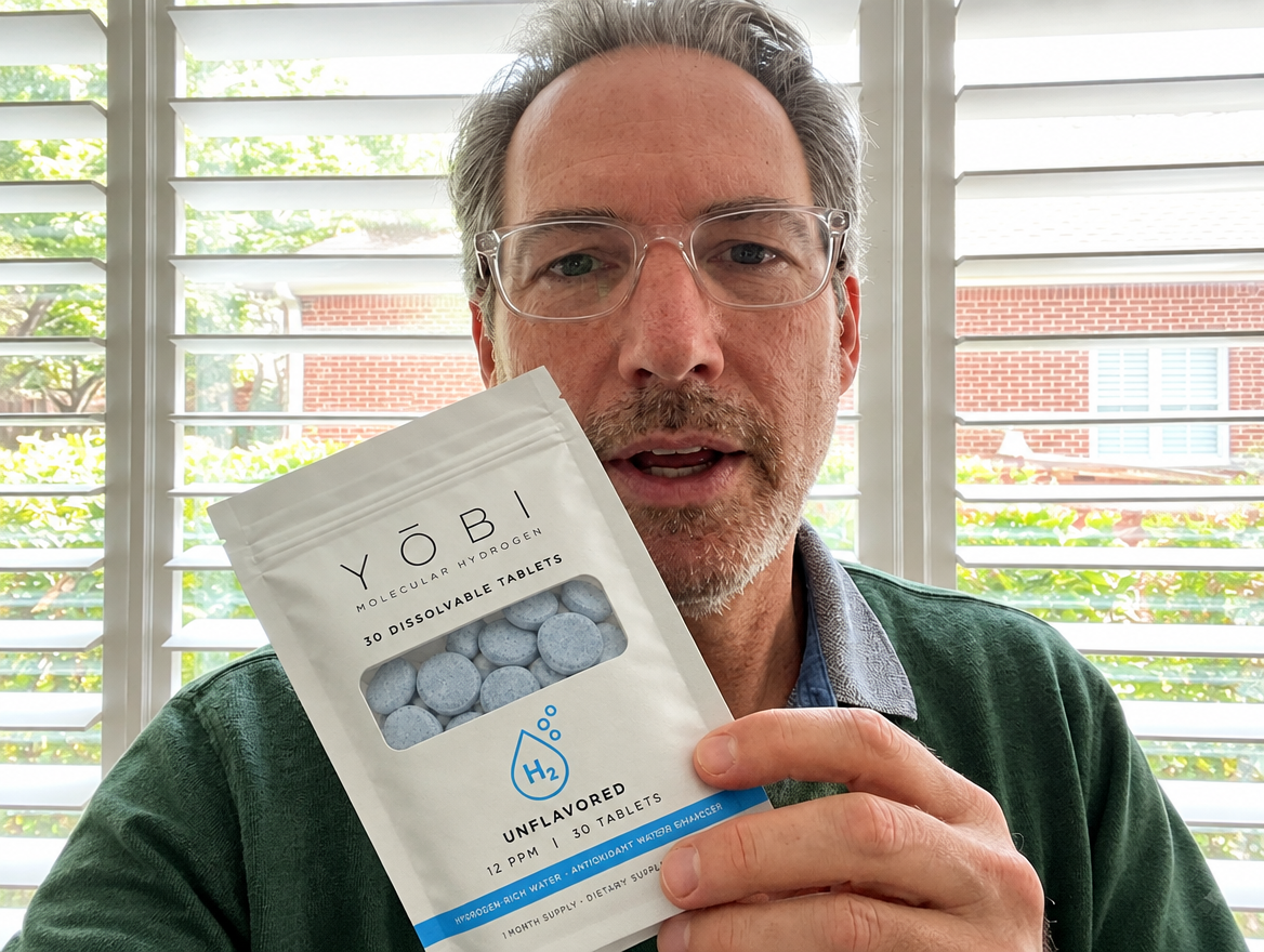Daniel holding his YŌBI pouch by a sunny window