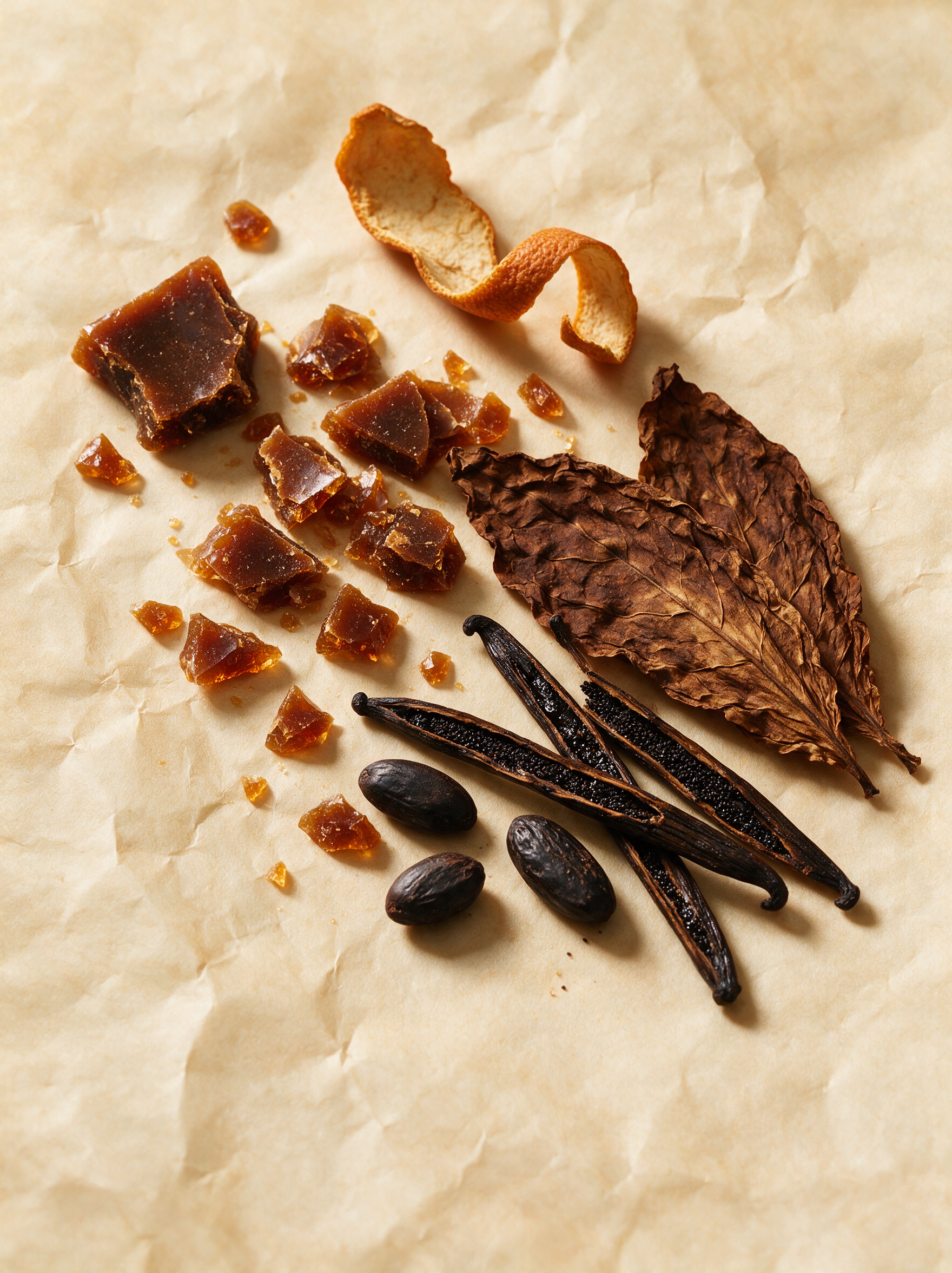 Caramelised sugar shards, orange peel, tobacco leaves, vanilla pods and tonka beans on parchment