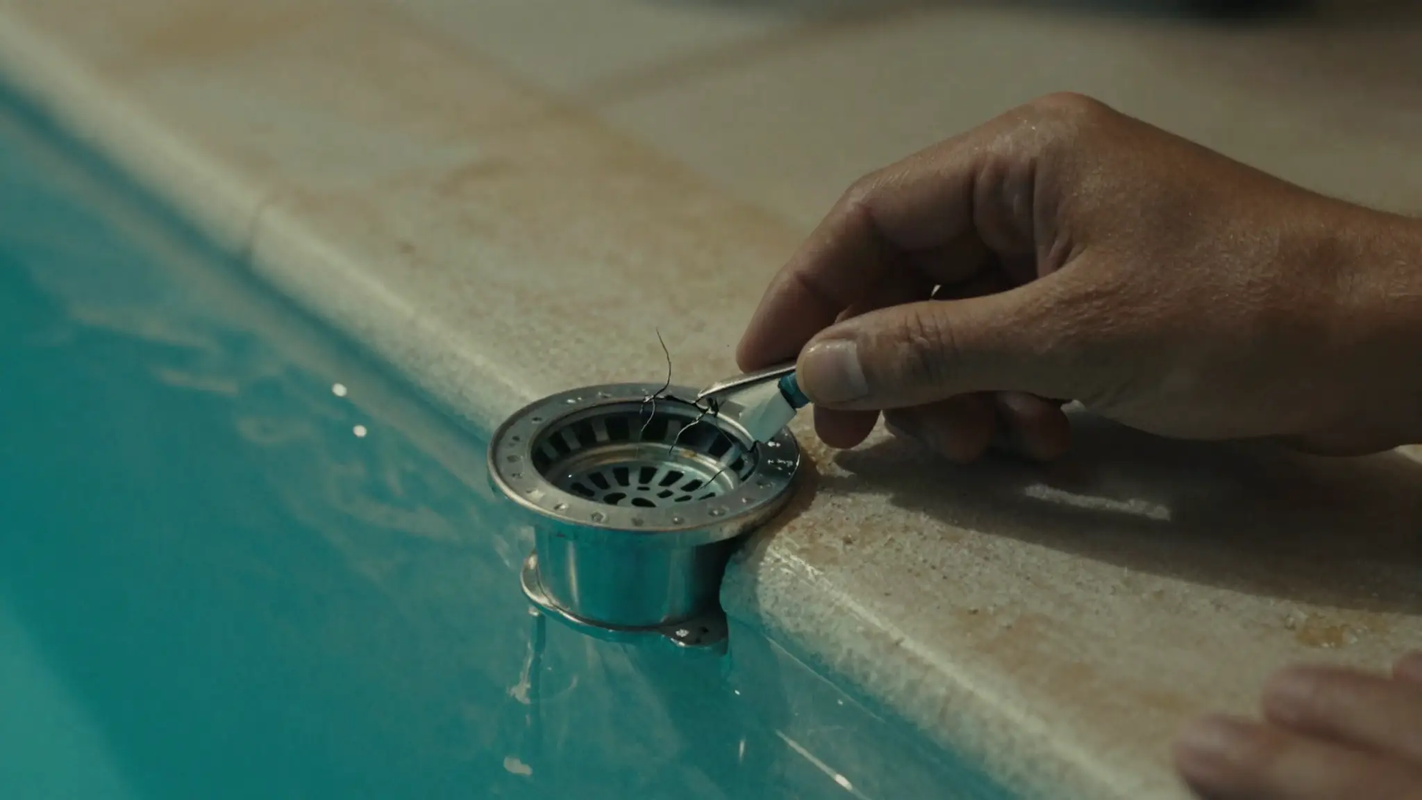 inspecting a pool skimmer for cracks and gaps during DIY pool leak testing