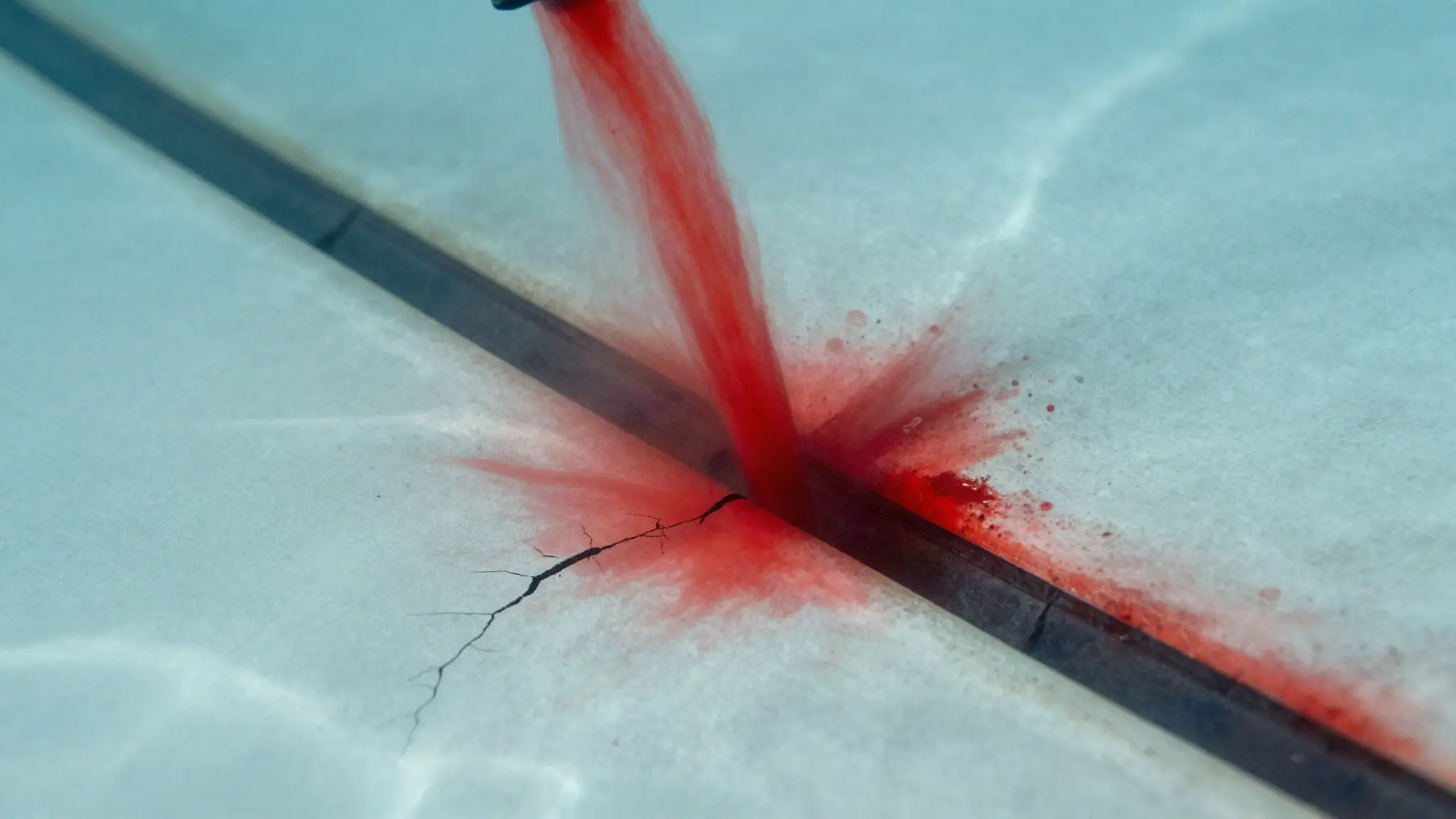 dye test near a pool crack revealing water movement during pool leak detection