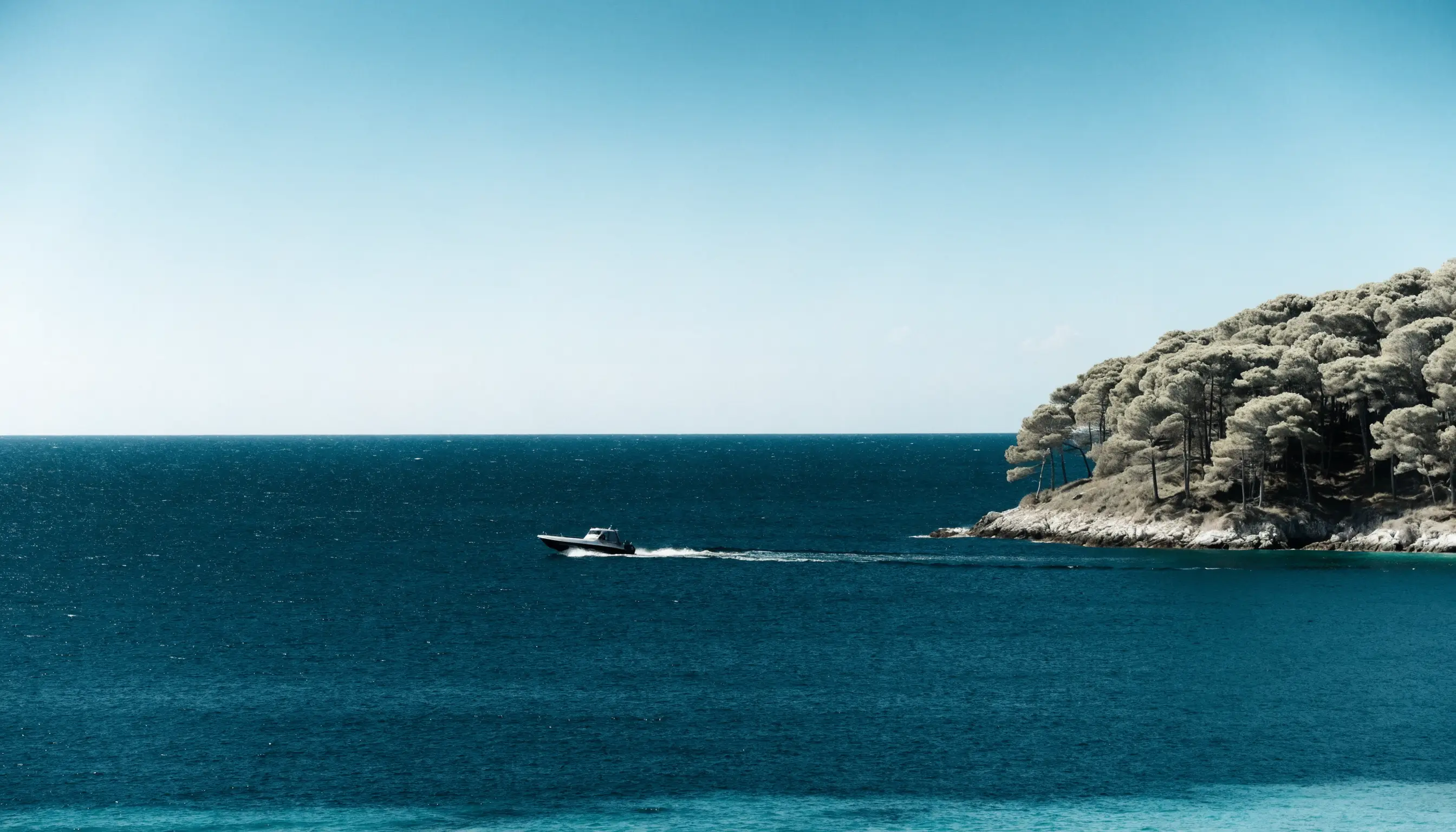 A fast motor boat under way on flat blue Mediterranean water