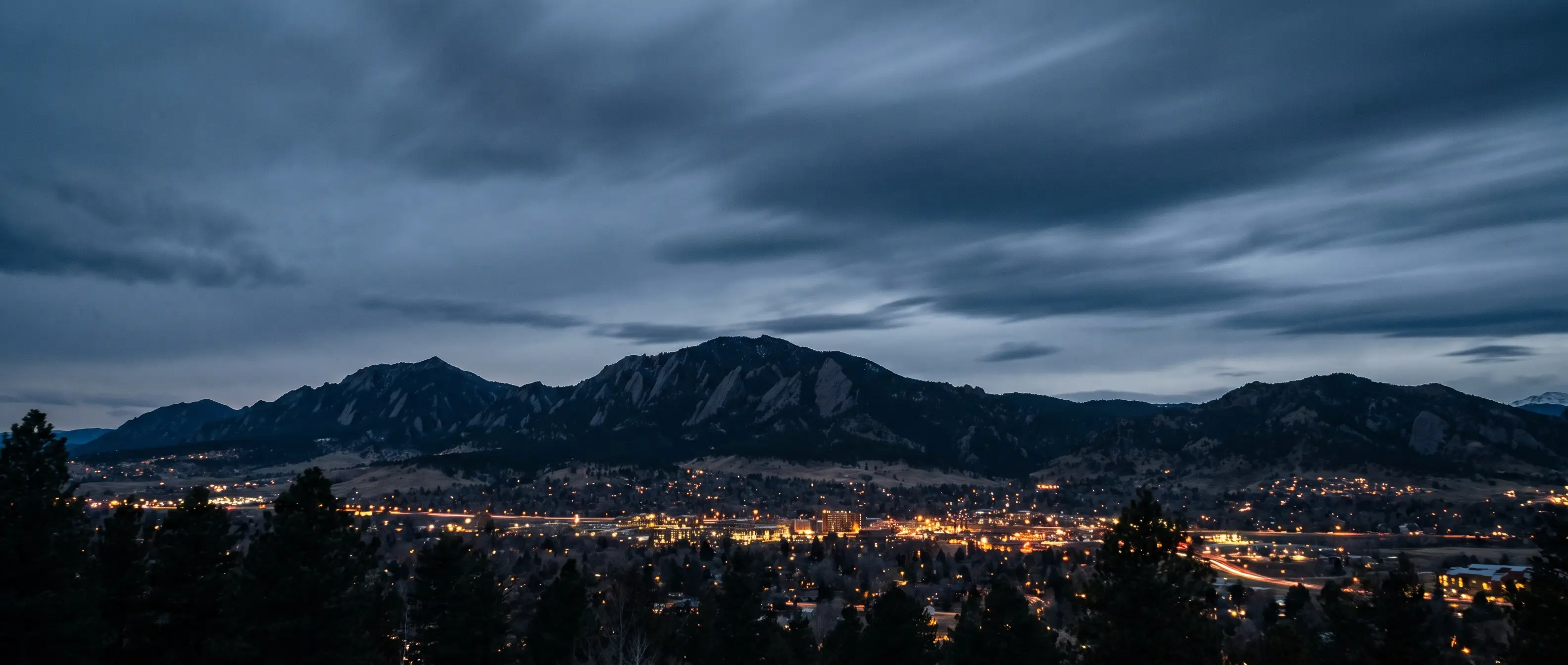 The Flatirons of Boulder, Colorado at blue hour with city lights below