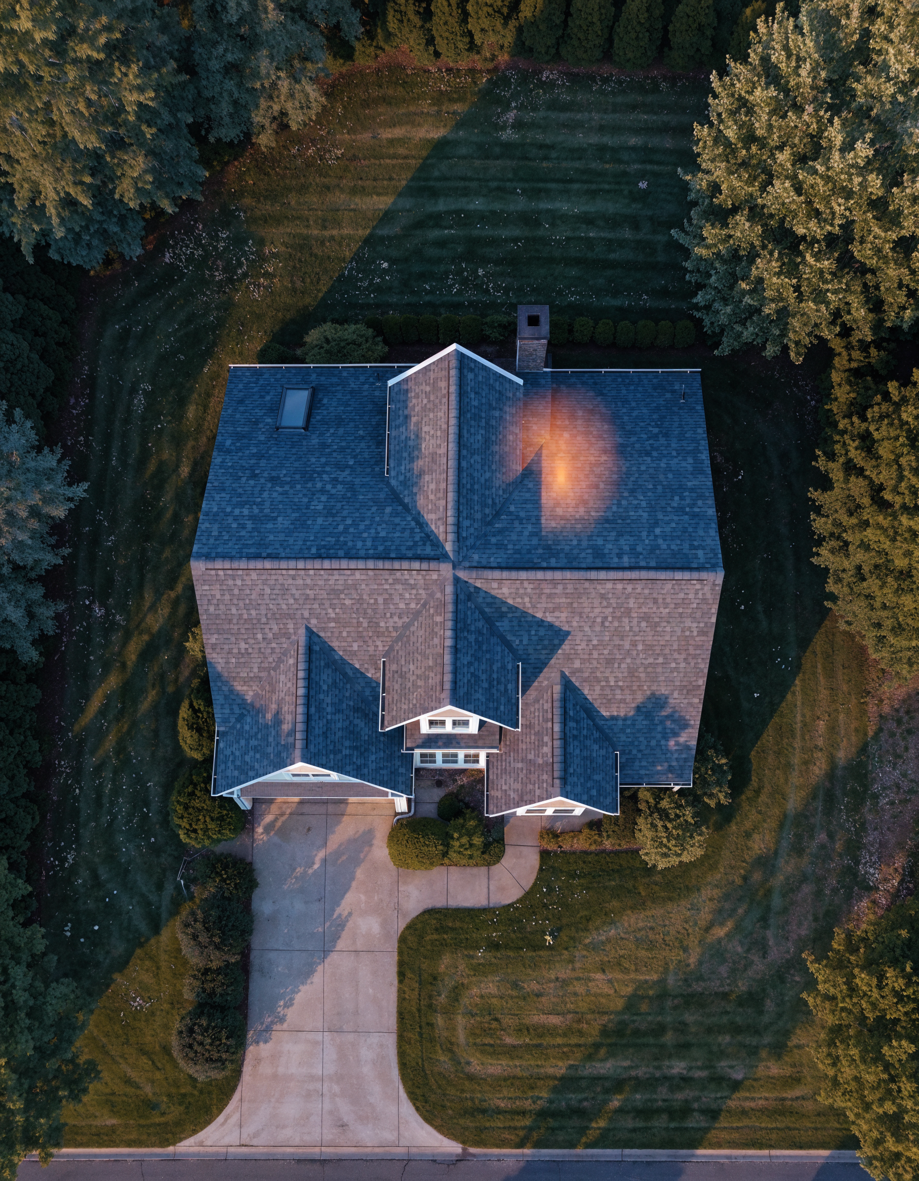 Aerial view of the home's roof with the detected moisture zone highlighted in amber near the north eave