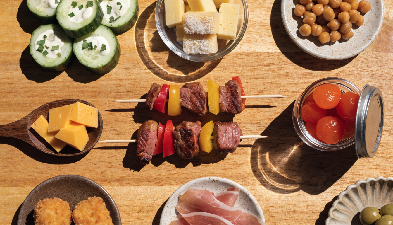 An assortment of fast snacks including cucumber boats, roasted chickpeas, and skewers