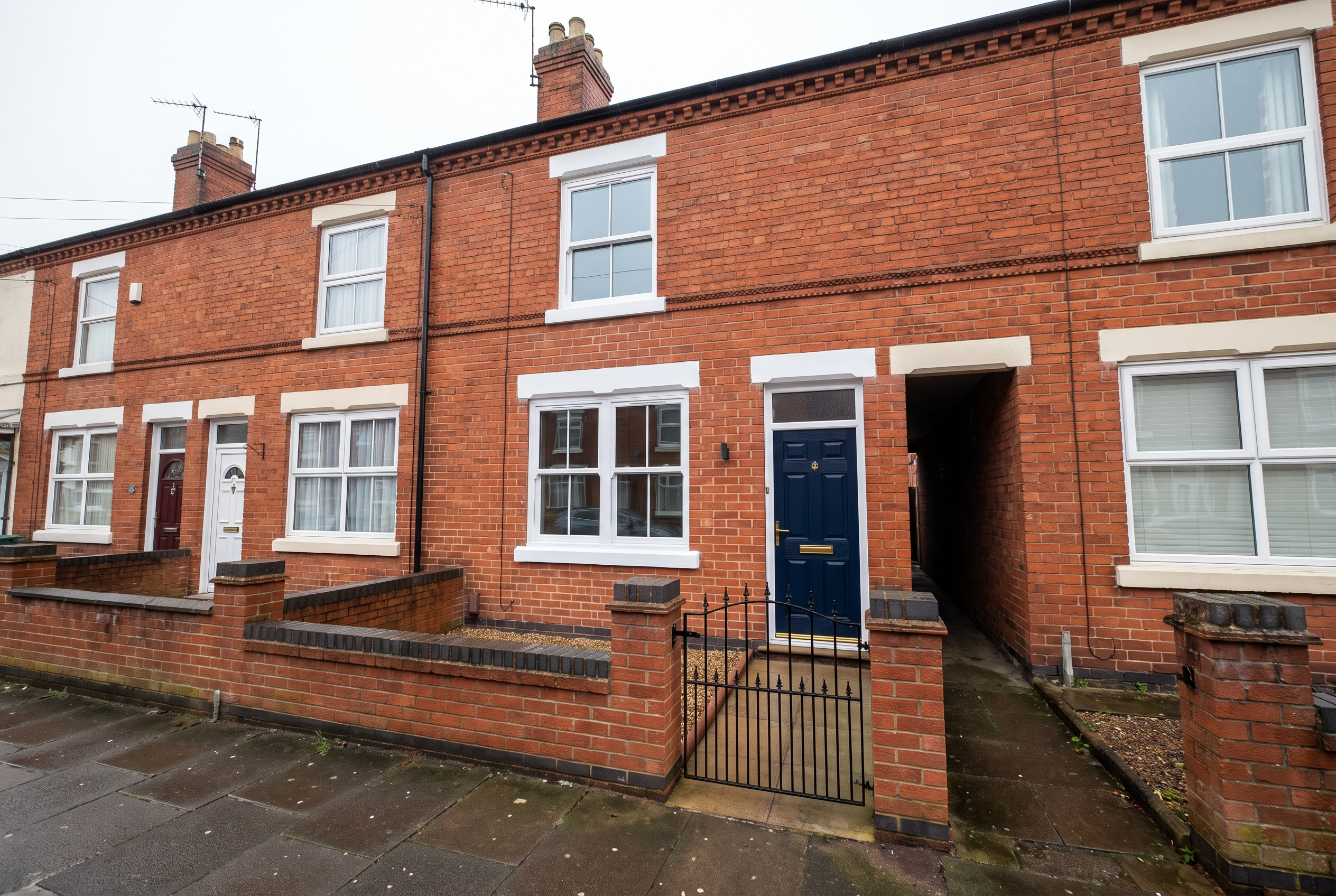 Refurbished Victorian mid-terrace house with a navy front door